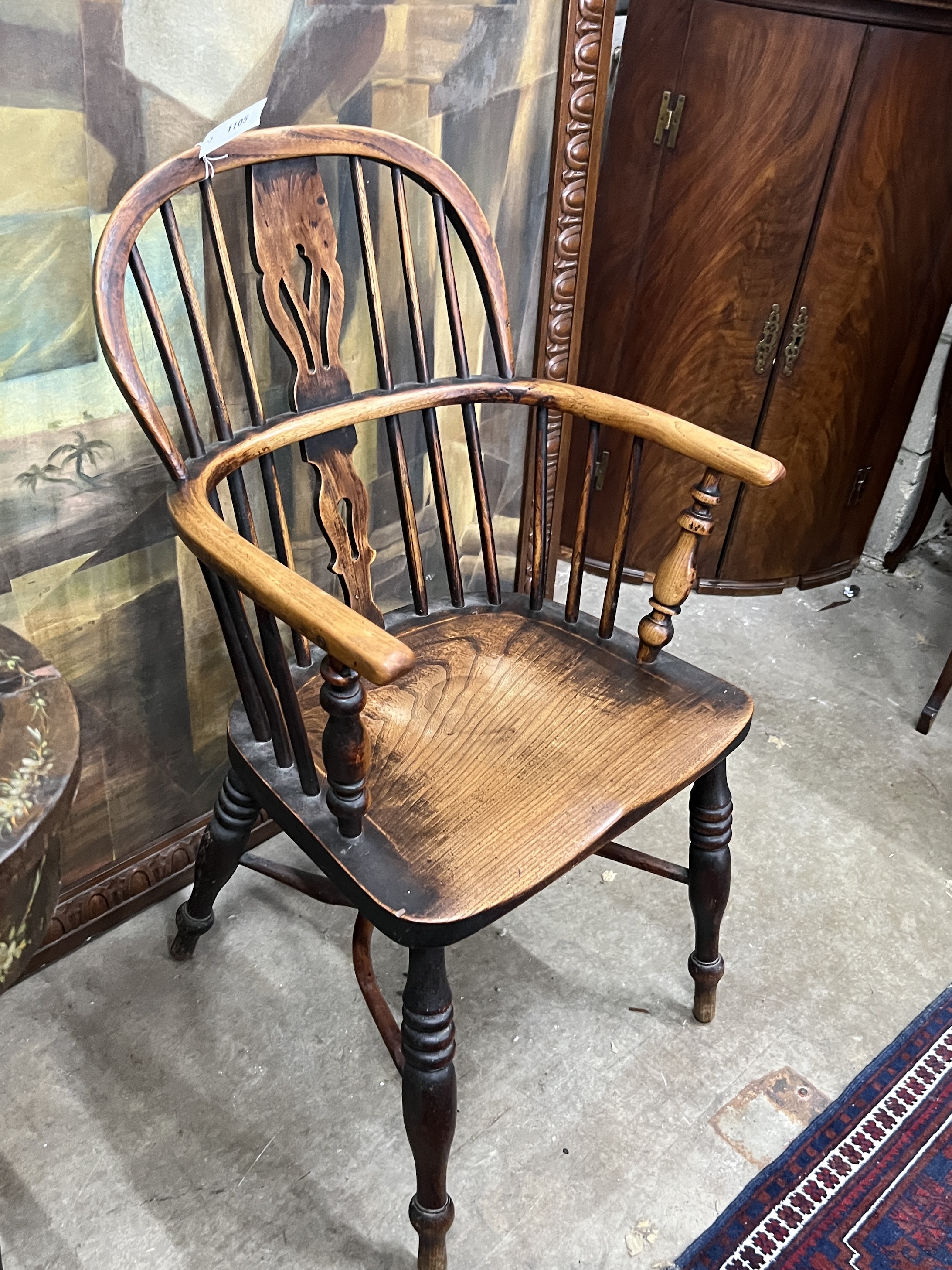A 19th century Windsor ash and elm comb back elbow chair with crinoline stretcher, width 54cm, depth 40cm, height 94cm
